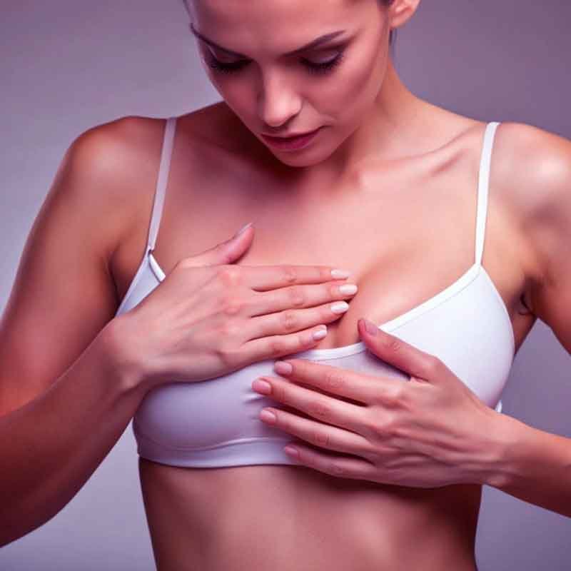 A lady showing how to self exam breast cancer
