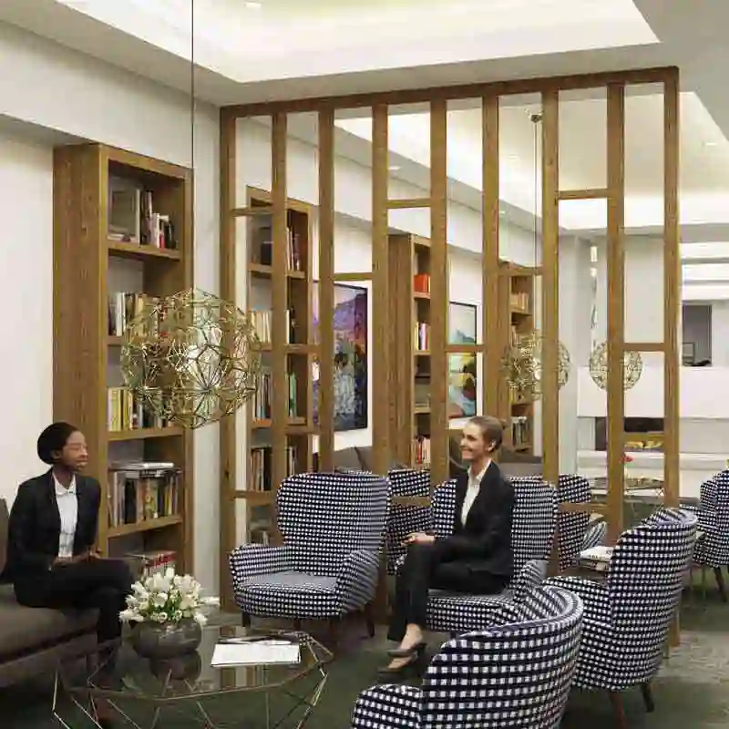 Still frame from a retirement home 3D walkthrough showing two women conversing in the lobby